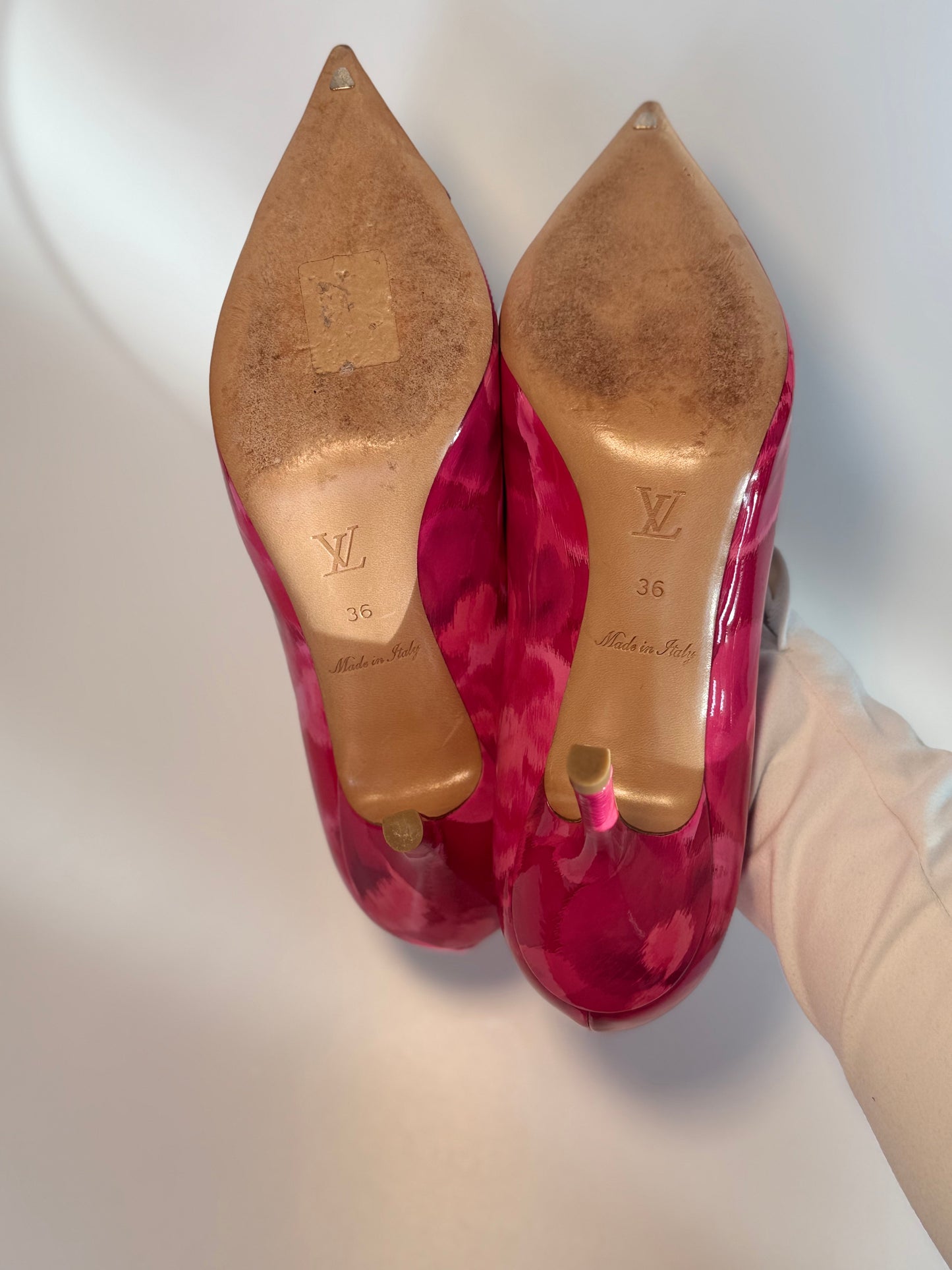 Bottom view showing sole wear of Louis Vuitton heels